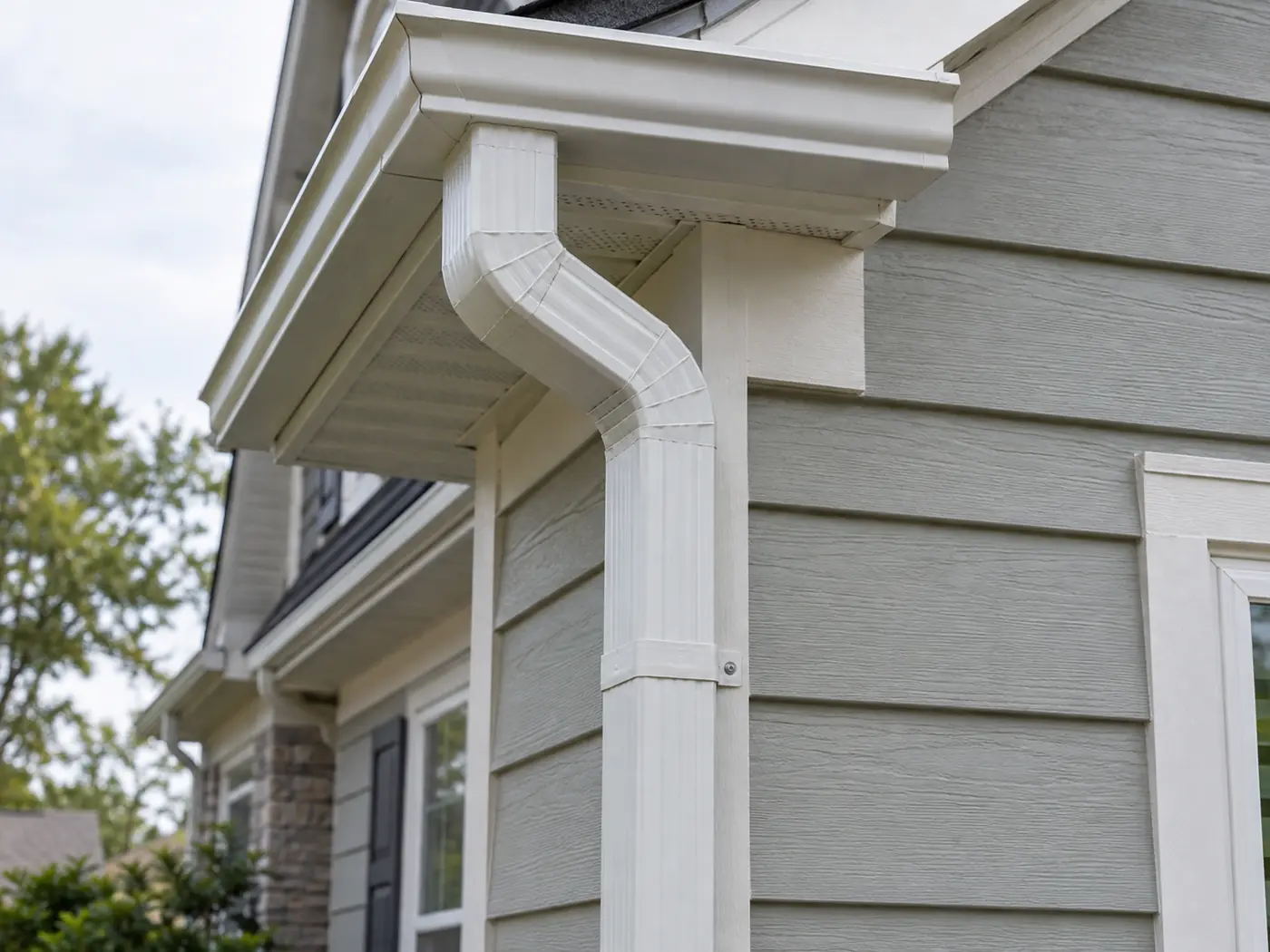 Rectangular 3×4 downspout connected through elbows to a residential K-style gutter