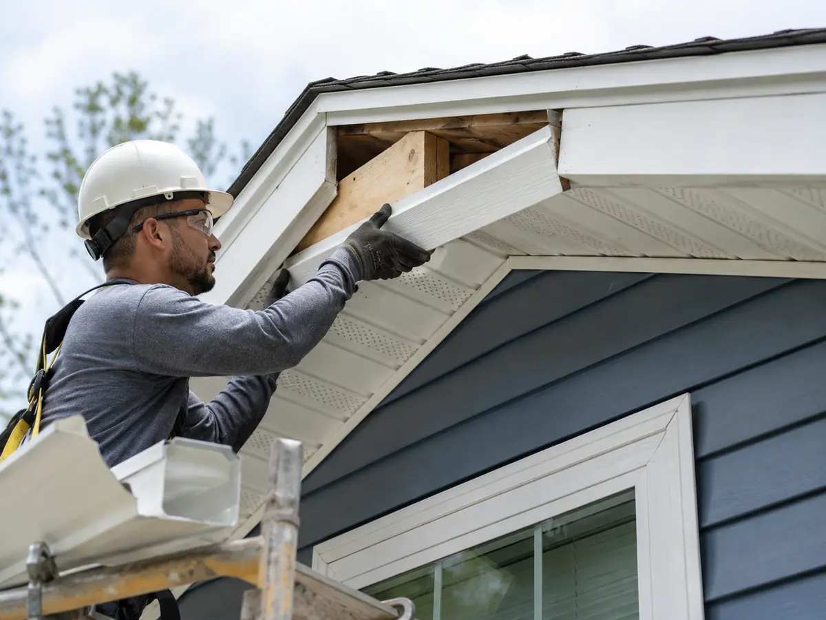 Fascia and Soffit Repair Durham NC Safety-equipped contractor completing fascia and soffit repair on a Durham NC home