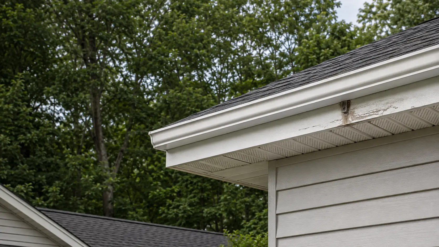 Fascia and Soffit Repair Durham NC Localized damaged white fascia beside vented soffit and a K-style gutter in Durham NC