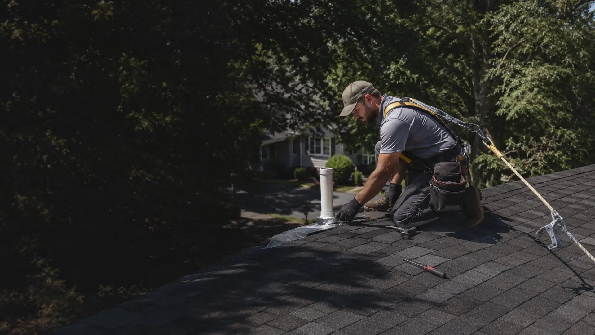 Roofing Contractor Durham NC Safety-equipped roofing contractor repairing an asphalt shingle roof in Durham NC